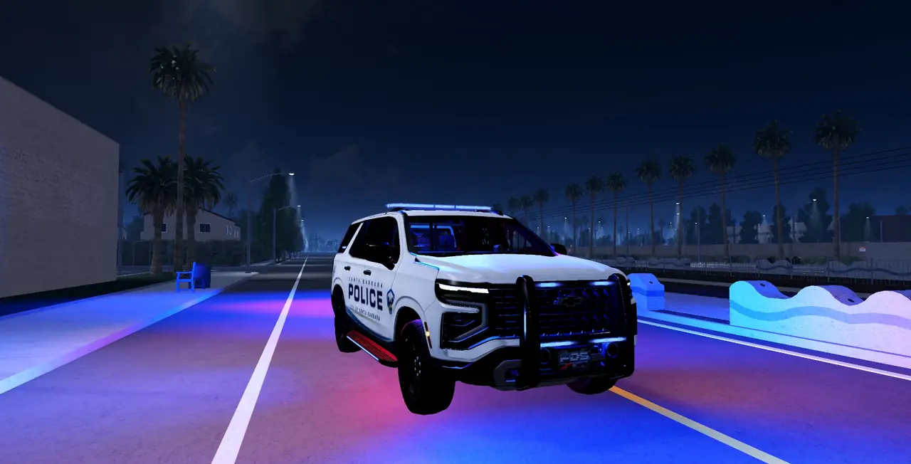 A Santa Barbara Police Tahoe with its lightbar on at night