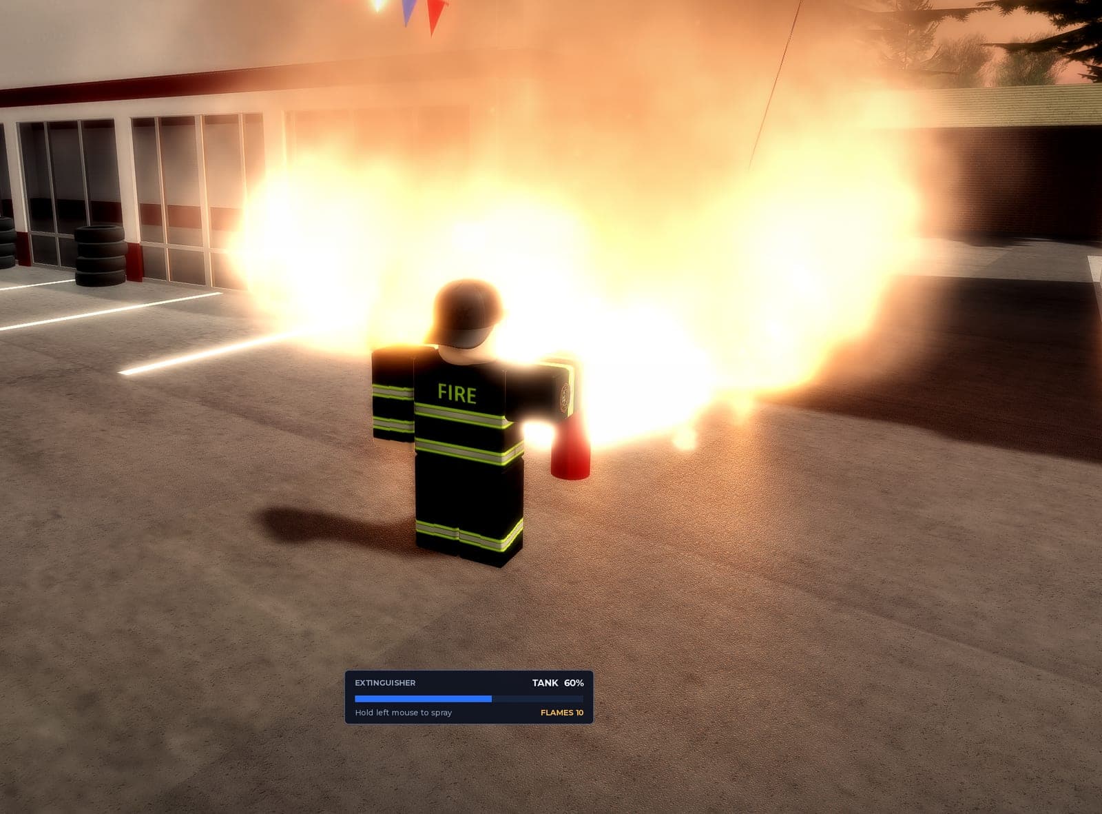 A firefighter spraying an extinguisher at a fire outside the station